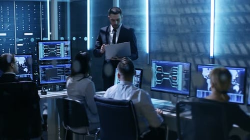 Professional IT Engineers Working in System Control Center Full of Monitors and Servers. Supervisor