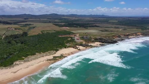 Aerial view of sandy beaches and waves.