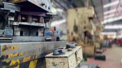 An industrial bending in a large factory hall. Panning shot.