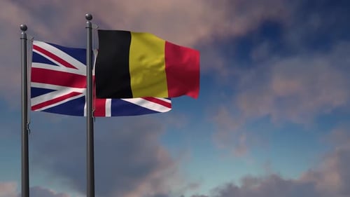 United Kingdom and Belgium Flags Waving Against Cloudy Sky
