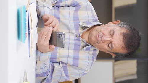 Adult Using Smartphone and Planner Indoors