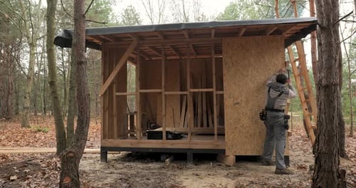 Man Worker Building Wooden Frame House