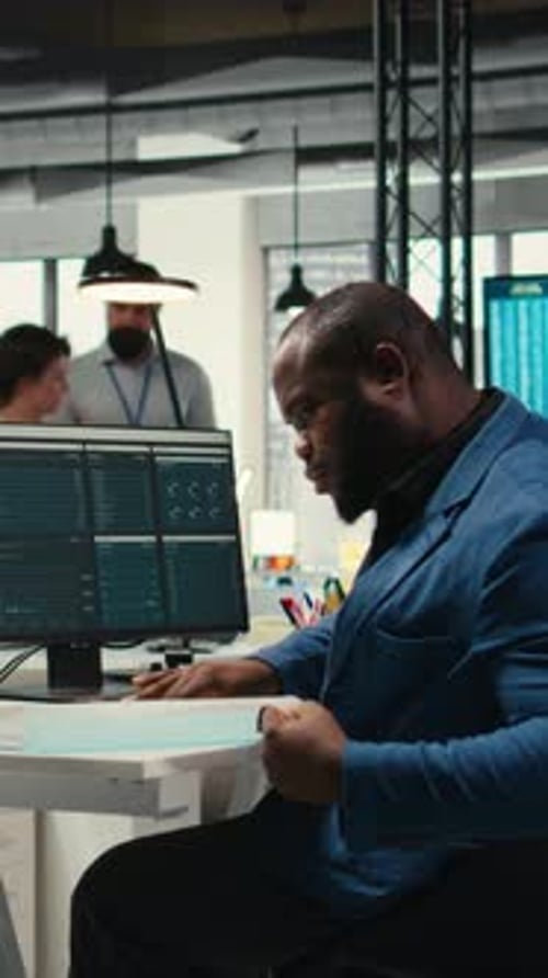 Vertical Video Black Male Administrator in Modern Workspace Analyzing Forecast Insights