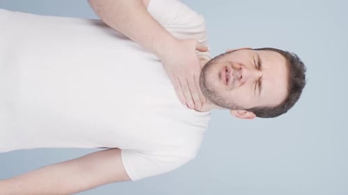 Man Experiencing Sore Throat Pain and Discomfort