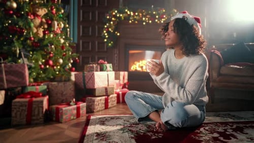 Young Woman Enjoys Christmas in Cozy Decorated Home