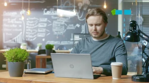 Handsome Young Office Employee Finishes His Work Closes Laptop Computer and Charmingly Smiles on Ca