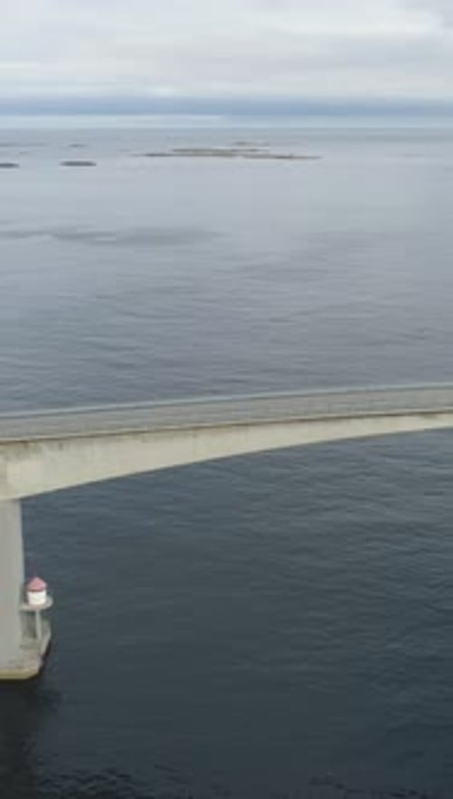 Motorhome Car Travels on Storseisundet Bridge Atlantic Ocean Road in Norway Aerial View Vertical