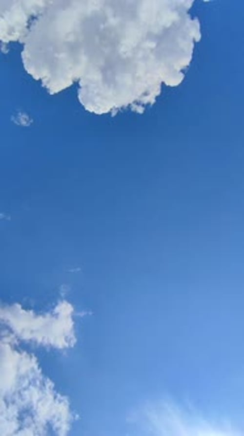 Clouds Drifting Gently Across a Vivid Blue Sky