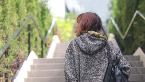 4K Young Asian woman go to university in the morning.