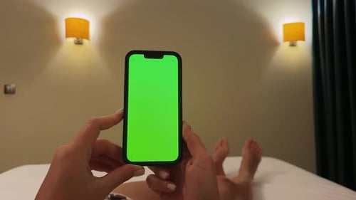 Woman in Living Room with Green Screen Phone in Hands Young Female Addiction to Gadgets Watching