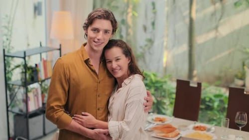 Happy Young Couple Embracing at Home