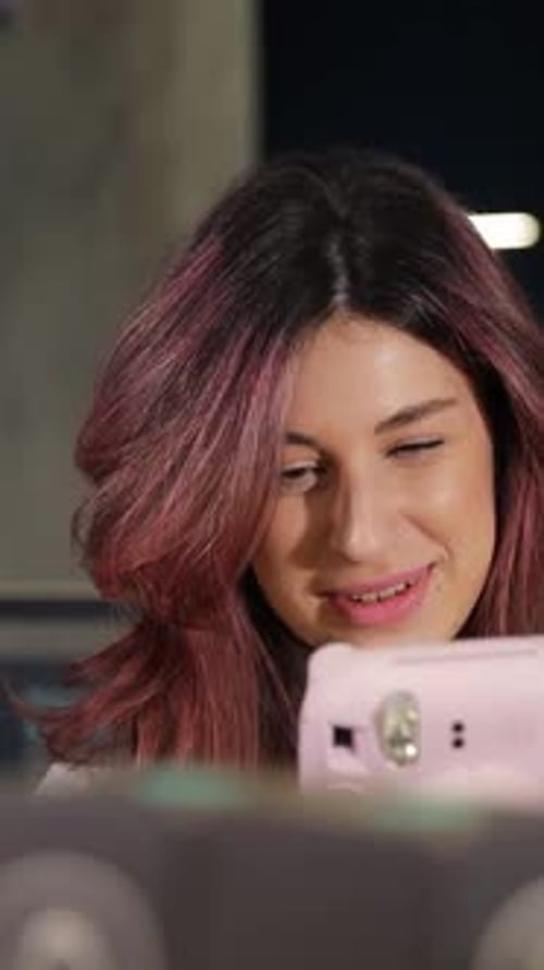 Positive Smiling Girl Chooses Digital Camera in Digital Store Vertical Video