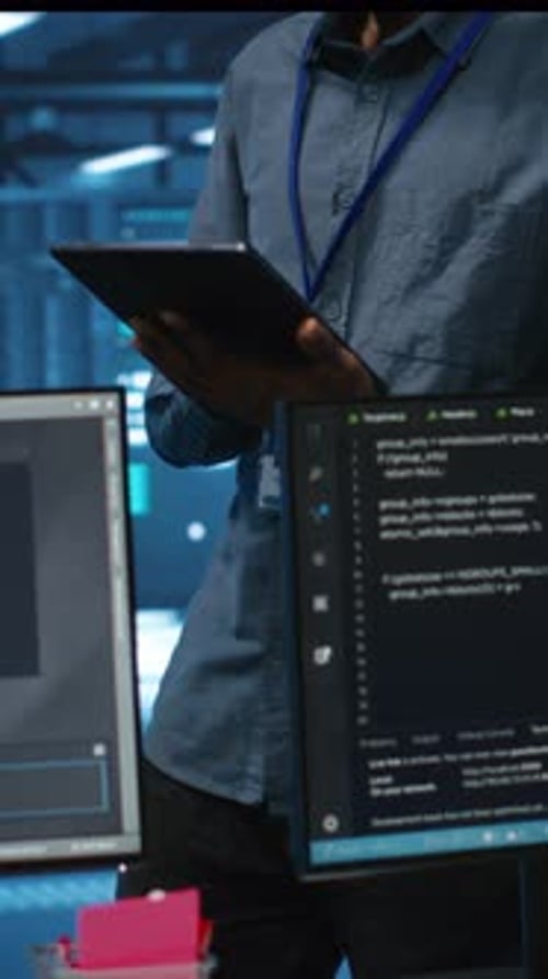 Vertical Video Technician in Server Hub Using Tablet to Find Hardware Misconfigurations