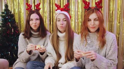 Festive Friends Enjoying Christmas, Eating Oranges