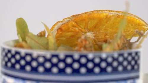 Linden Flower and dried orange in mug herbal remedy