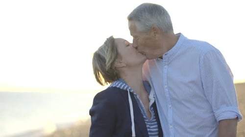 Portrait of Retired Senior Couple kissing on the beach