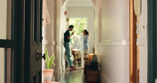 Couple Talking Indoors in Hallway with Open Door