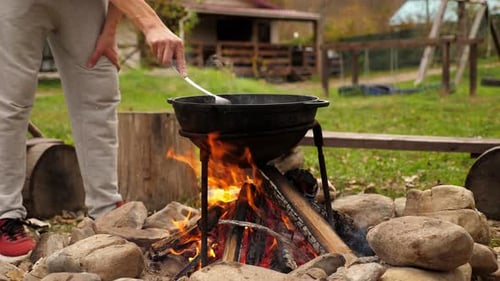 Closeup of a Black Cauldron on a Bonfire