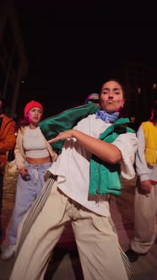 Young Adults Energetically Dancing Together at Night