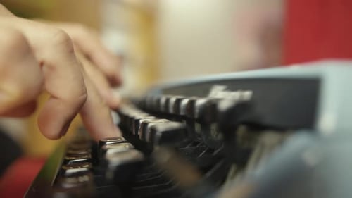 Close Up Hands Typing on Vintage Typewriter