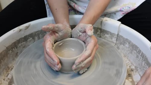 Potters Molding Clay on a Pottery Wheel