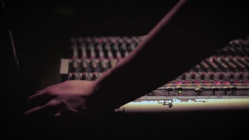 A close up of a mixing board at a concert
