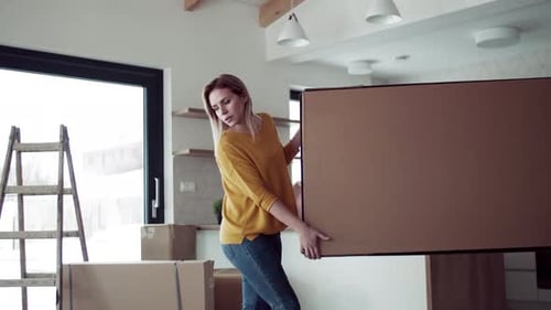 Couple Moving Boxes into New Home Together