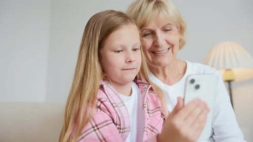 Grandmother and Granddaughter Making a Video Call Together