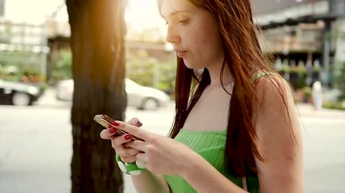 Young Woman Using Smartphone in City Environment