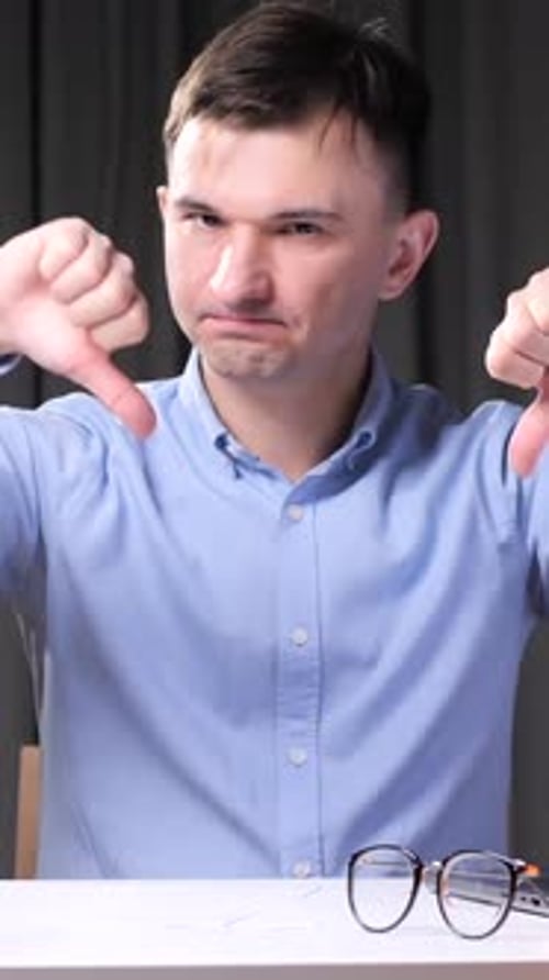 Vertical Video Office Worker Showing Thumbs Down Gesture at Workplace