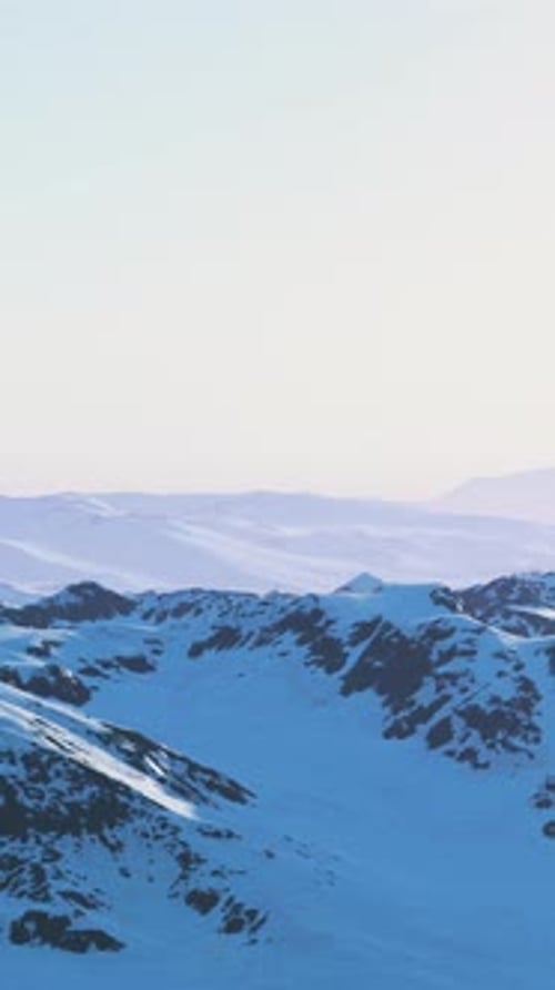 A Majestic Snowcovered Mountain Range Under a Clear Blue Sky