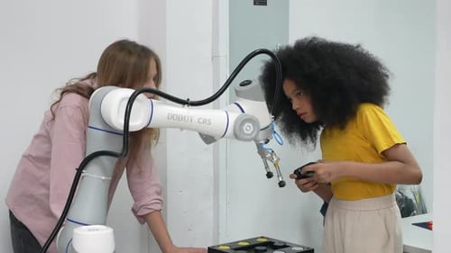 Diverse schoolkids working on robotic technologies at STEM educational class.