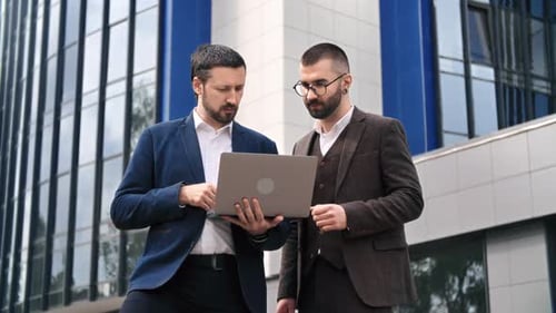 Two Fashion Business Man Colleagues Discuss Project Brainstorming Use Laptop Downtown Office Street