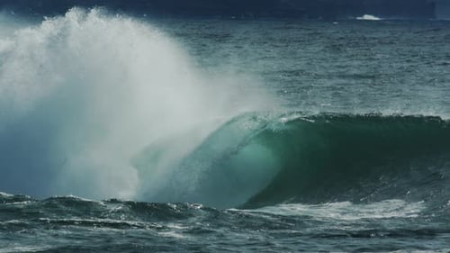 Teal Ocean Wave Crashing Powerfully on the Shore