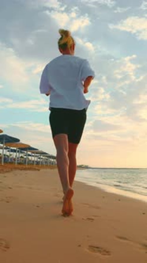 Morning Jog on Sandy Beach in Summer Vacation Rear View of Athletic Lady Healthy Lifestyle and