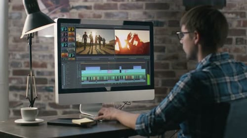 Video Editor Works with Footage and Sound on His Personal Computer. His Office is Modern and Creat