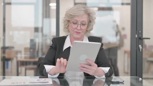 Senior Businesswoman Using Digital Tablet