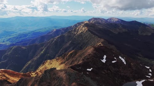 Aerial shot of majestic Dolomites mountain range with dramatic peaks and valleys