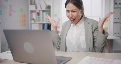 businesswoman crazy with overworked stress angry massive work scream at office.