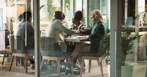 Business Meeting Concludes With Handshake in Bright Office