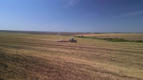 Tractor working on the field doing tillage with cultivator