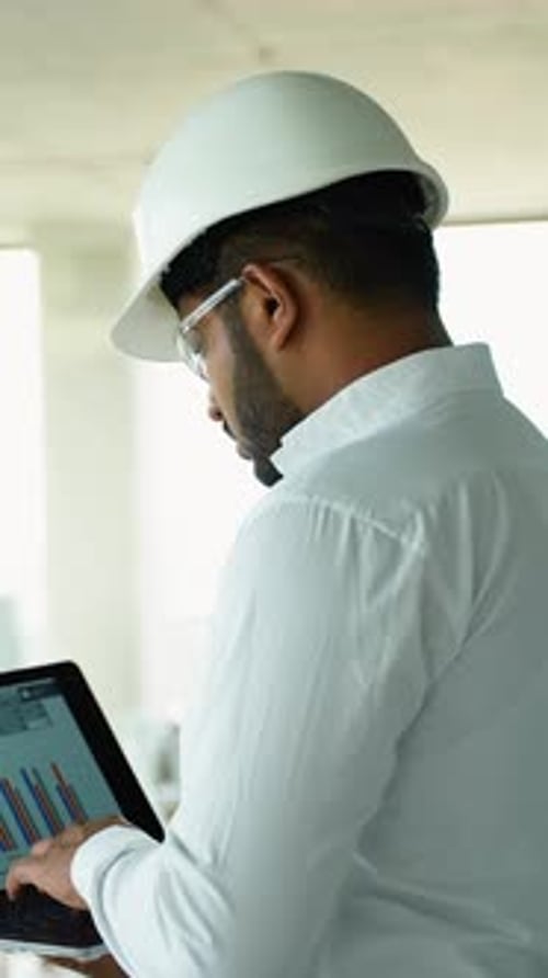 Engineer Uses Laptop Inside Construction Site