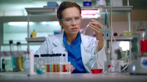 Woman Scientist Examining Test Tube in Laboratory