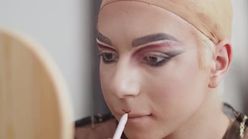 Young Adult Applying Red Lip Liner Close Up