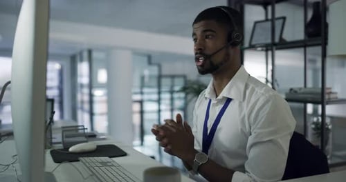 Young Adult Man Working at Computer in Office