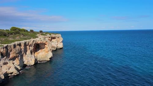 Explore stunning coastal cliffs of Cala Varques in Majorca on a sunny day