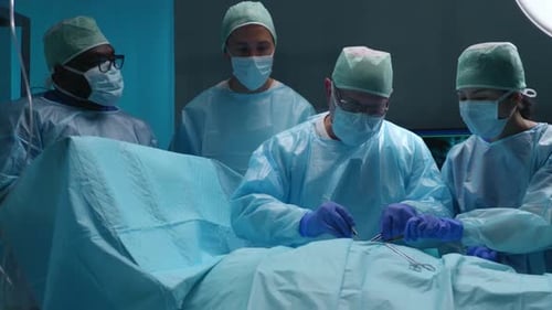 Team of Professional Medical Surgeons Performs the Surgical Operation in a Modern Hospital Doctors