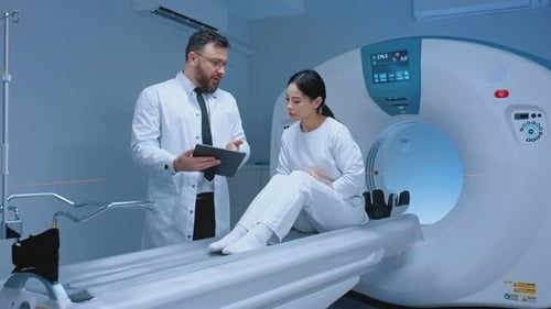 Doctor Consults with Patient Before CT Scan