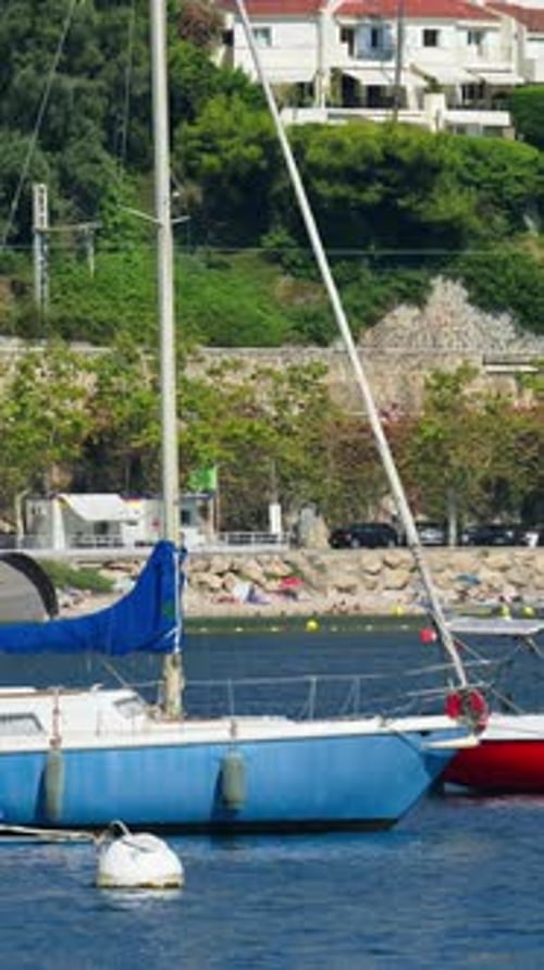 Boats docked in the local harbour in Villefranche sur Mer, France. Vertical