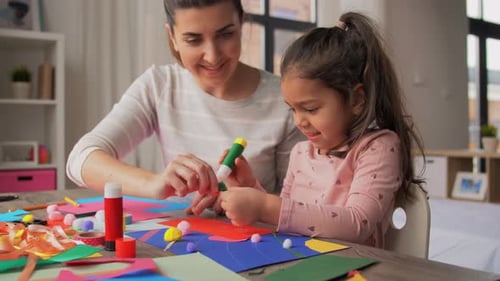 Family, Art And Craft Concept - Mother Spending Time With Her Little Daughter With Glue Making Ap...
